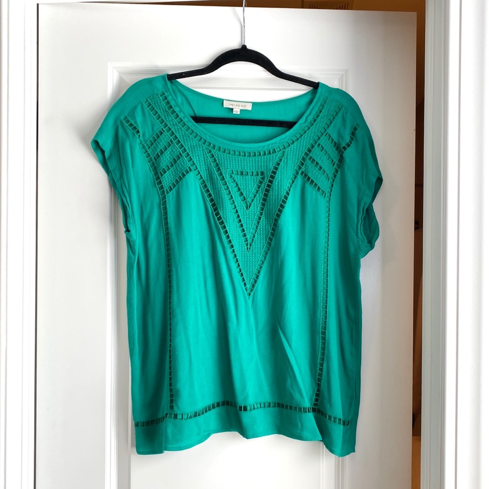 Green cap sleeve blouse with eyelet detail.